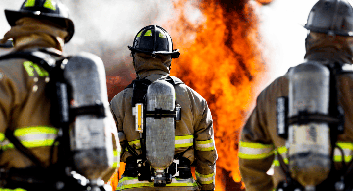 Firefighters face a blazing fire